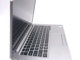 a silver laptop computer sitting on top of a white table