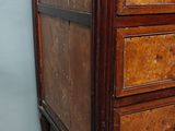 a small wooden chest of drawers with drawers on it