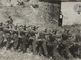 a group of soldiers that are standing in front of a building