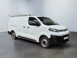the white van is parked in a large room with a black floor