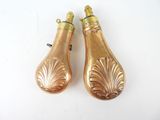 pair of gold plated salt and pepper shakers on a white surface