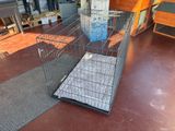 a cage with a dog inside of it on the floor