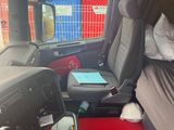 a bed in the back of a van with a red mat on the floor