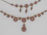 un gros plan sur un collier et une paire de boucles d'oreilles