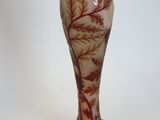 a glass vase with a tree on it on a stand