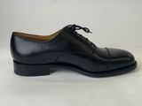a pair of black leather shoes on a white background