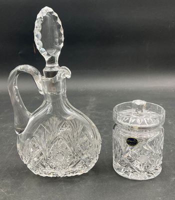 pair of cut glass decanters and a glass jar