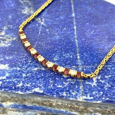a close up of a necklace on a blue marble surface