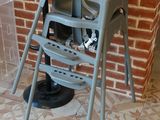 an image of a baby high chair in front of a brick wall