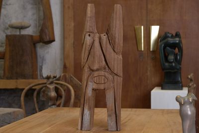 une sculpture en bois posée sur une table dans une pièce