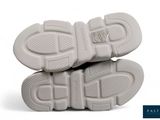 two pairs of white shoes are stacked on top of each other