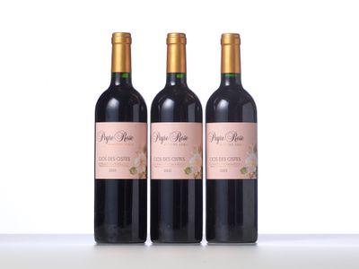 three bottles of wine sitting on top of a white table
