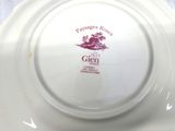 a white plate with a pink design on it