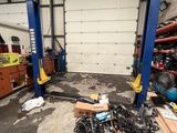 a picture of a garage with a lot of junk on the floor
