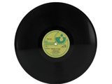 a black vinyl record with a green label on it