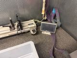 a laptop and a monitor on the floor in a room