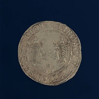 an old silver coin with an eagle on it on a black background
