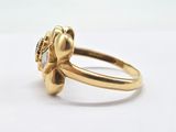 a close up of a gold ring on a white surface