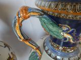 a blue vase with a dragon handle on a table