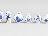 several blue and white vases are lined up in a row