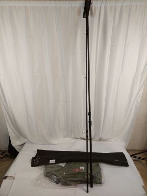 a bed with a white sheet and a black umbrella on it