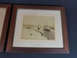 two framed photographs of ships in a harbor on a blue wall