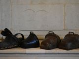 five pairs of shoes lined up on a ledge