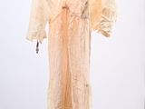 a dress hanging on a hanger in a room