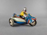 a figurine of a man riding a motorcycle with a dog on it