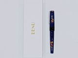 a pen that is laying next to a white box