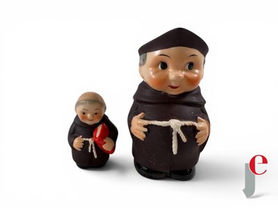 two figurines of a monk and a monk