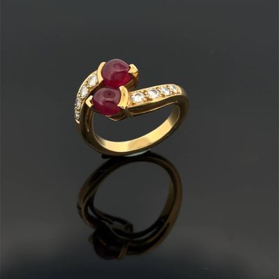 an image of a gold ring with a ruby stone and diamonds
