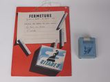 a red folder with a picture of a man on it next to a lighter and a lighter