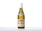 a bottle of white wine sitting on top of a table