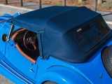 a blue car parked on the side of the road