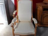 a white chair that is in a room with a red wall