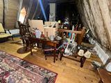 an image of a living room with a lot of stuff on the floor