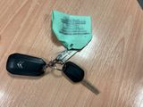 a keychain with two keys attached to it on a table