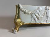 a white and gold plate with a picture of a man and a woman on it