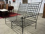 a metal bed frame in a room with pictures on the wall