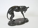 bronze statue of a cheetah standing on a base