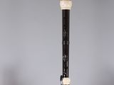 a close up of a black and white pipe on top of a table