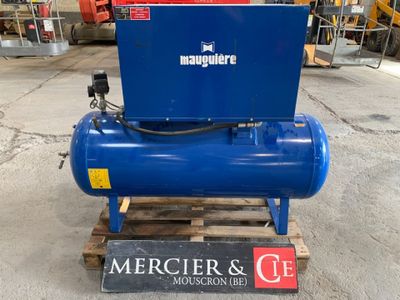 an air compressor sitting on top of a wooden pallet in a warehouse