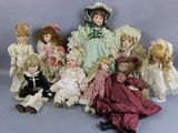 a lot of dolls that are sitting together on a table