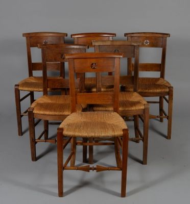 six wooden chairs are lined up in a row on a gray background