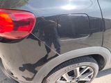 a black car parked on the side of the road