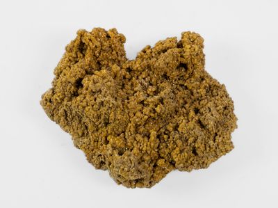 a close up of a pile of brown dirt on a white surface