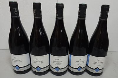 six bottles of wine are lined up in a row on a table