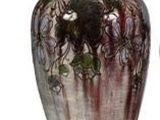 two vases sitting next to each other on a white surface