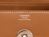 a close up of a brown leather bag with a metal handle